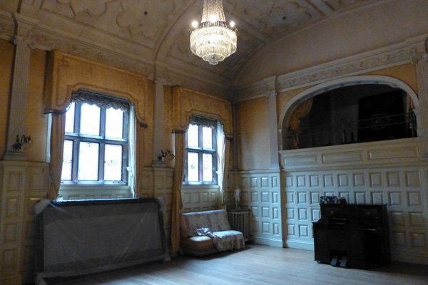The ballroom with silk wallhangings and crystal chandelier