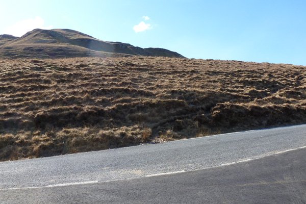 The start of the path, directly opposite the track on the opposite side of the road