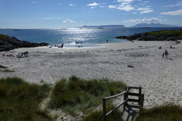 The wooden steps leading to a metal kissing gate with access to Camusdarach campsite